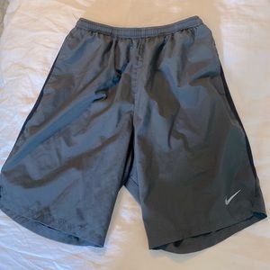 Nike running shorts. Grey with black trim. Side pockets. Small pocket inside.